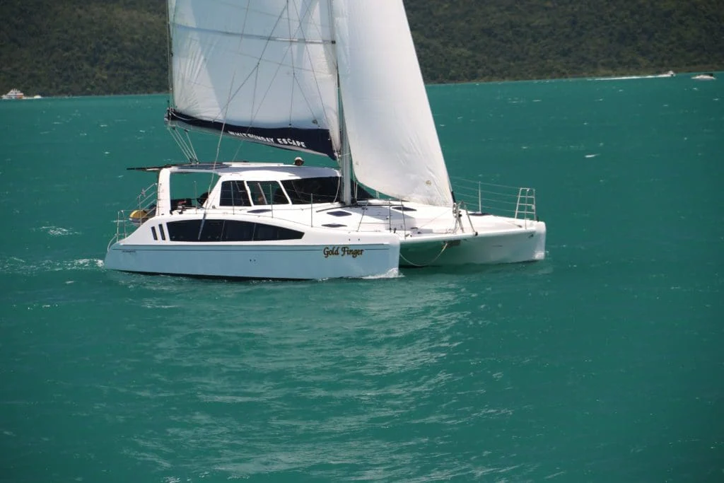 Goldfinger Seawind 1160 sailing catamaran under sail in the Whitsundays